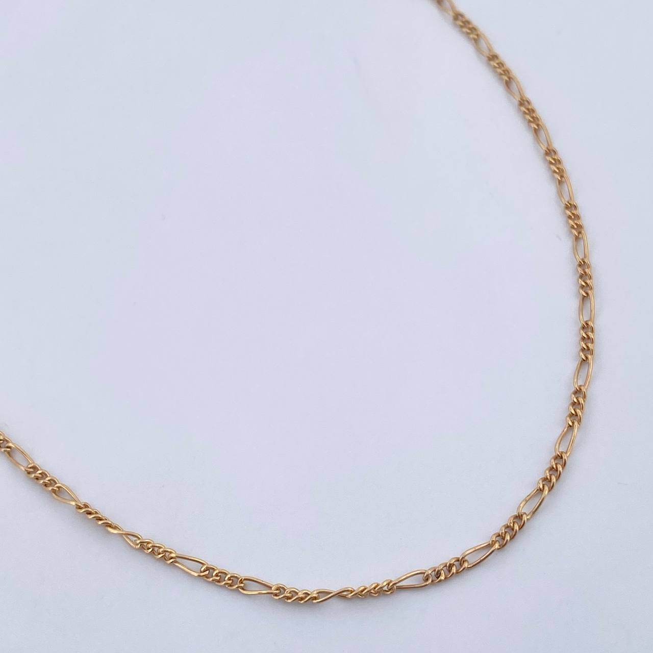 Cadena Figaro 1.45gr / 45.3cm / 1.2mm Oro Amarillo +1 18K $