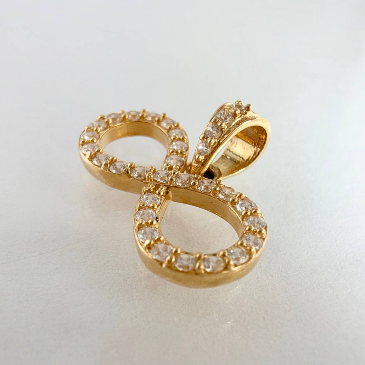 Dije Silueta Infinito Tupido 1.25gr / 3/4 in / Oro Amarillo 18K ©