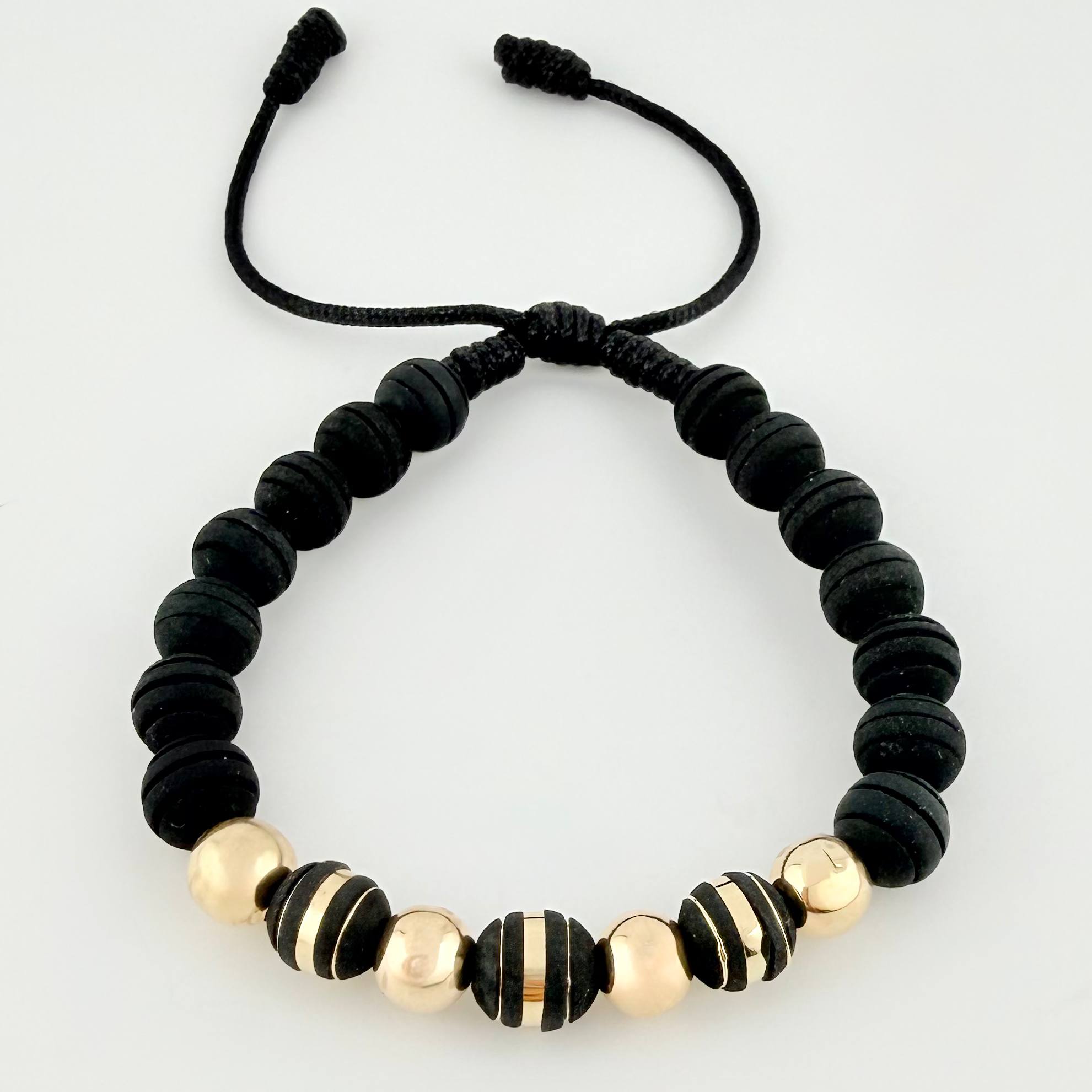 Pulsera Negra Neoros 3und Bolas 4und 1gr / 7mm Oro Amarillo 18K ©