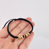 Pulsera Tejida Hilo Negro 4 Balines Lisos y Un Neoro Oro Amarillo 18K