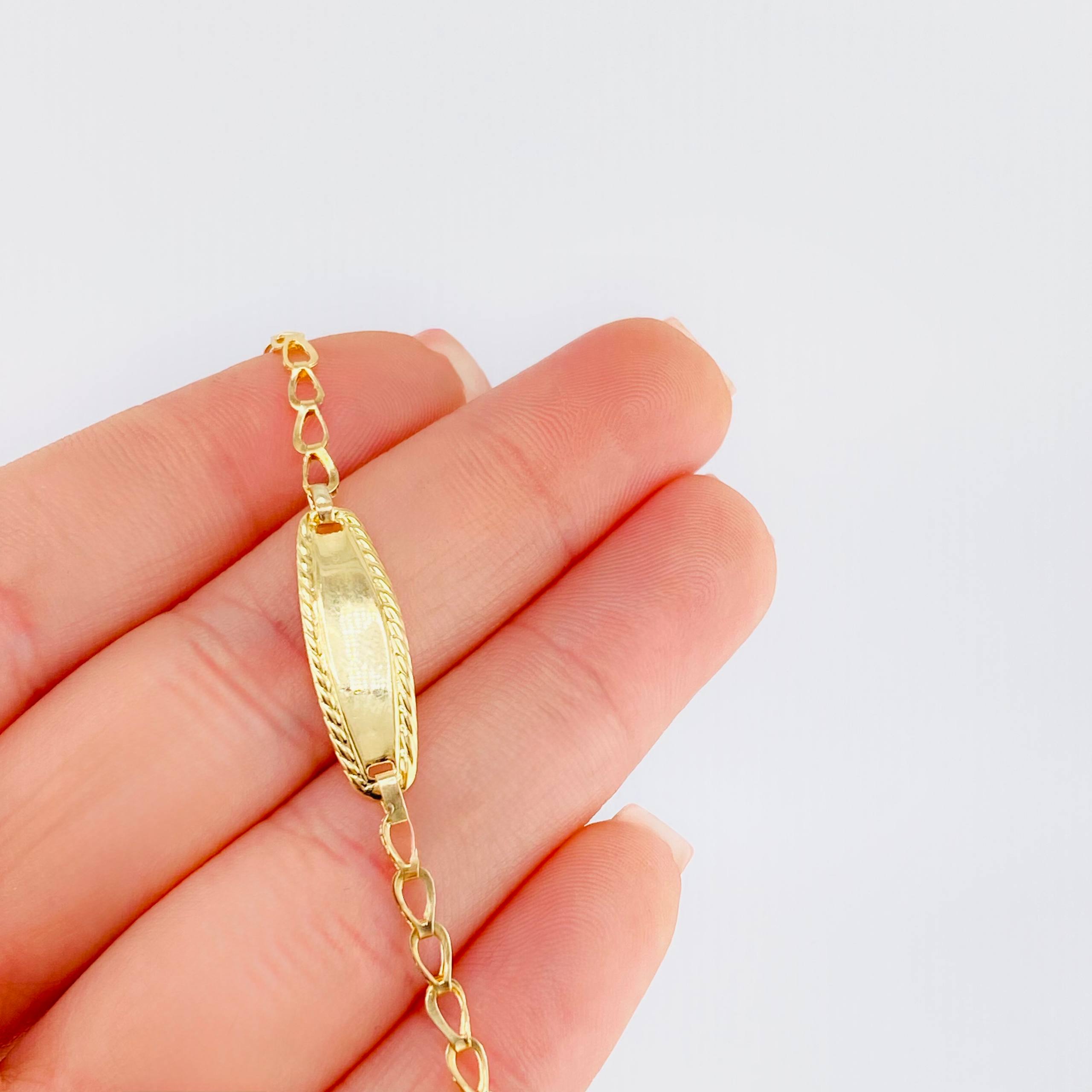 Pulso Bebé Espiga Placa Ovalada Bordeada 1.2gr / 5 3/4 in / 2.7mm Oro Amarillo 18K ©