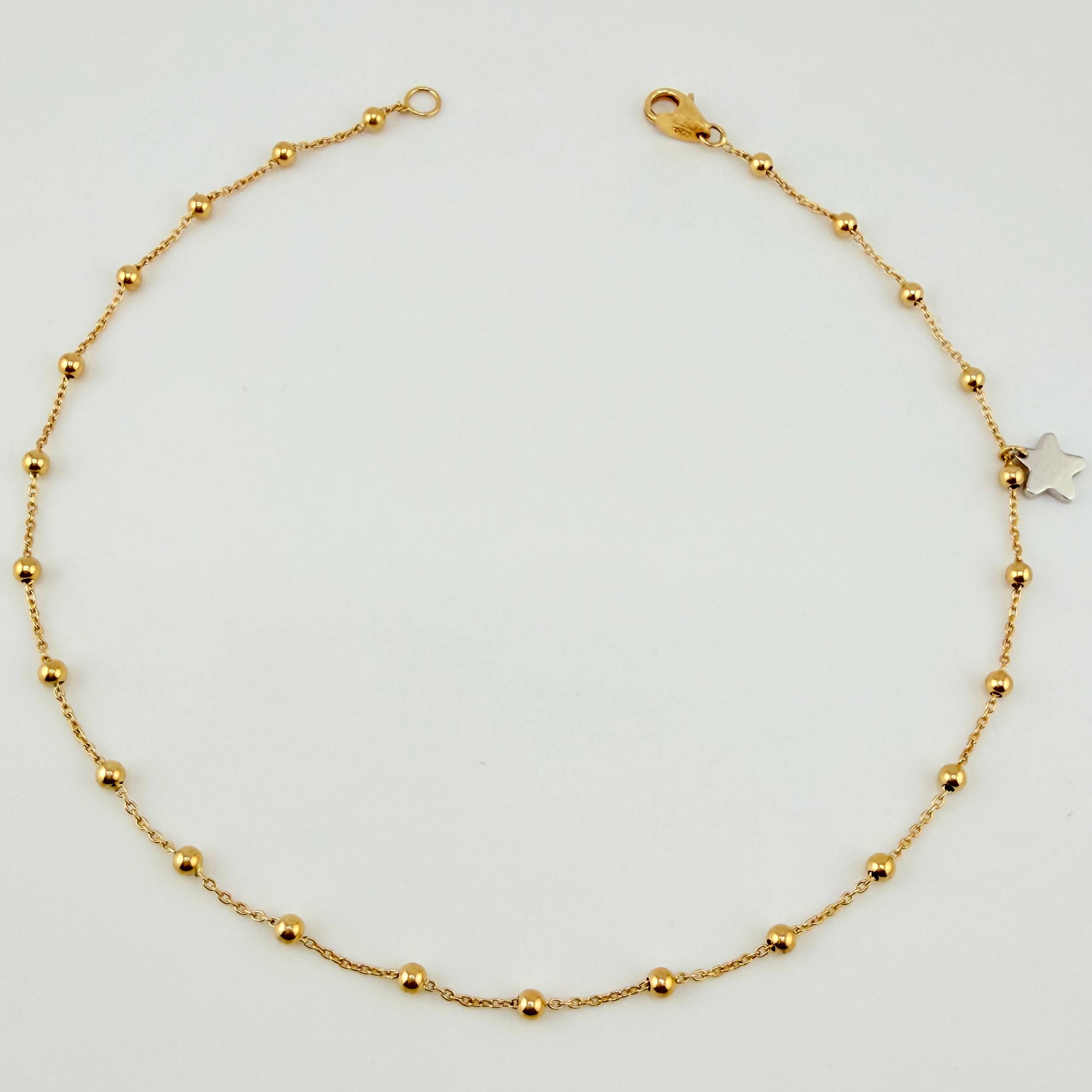 Tobillera Aro Seguido Dije Estrella 2.45gr / 9 3/4 in / 2.3mm Dos Oros Amarillo Blanco +4 18K