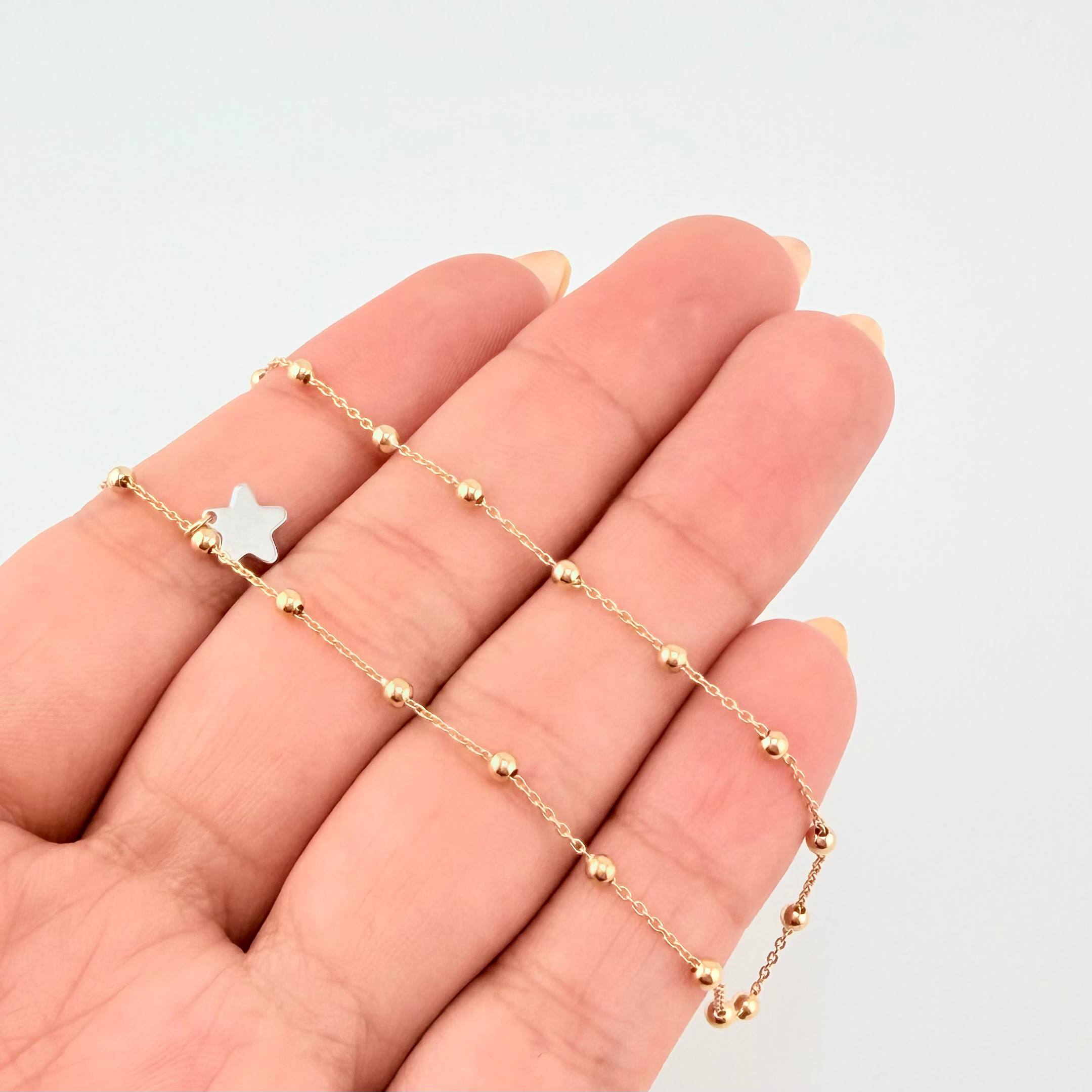 Tobillera Aro Seguido Dije Estrella 2.45gr / 9 3/4 in / 2.3mm Dos Oros Amarillo Blanco +4 18K