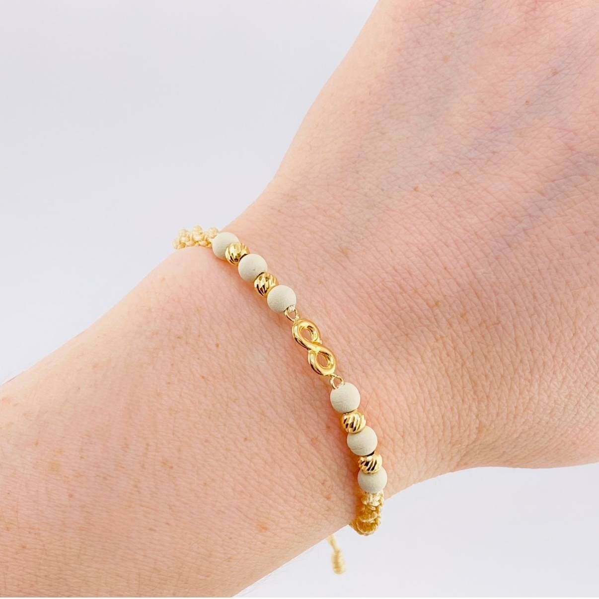 Pulsera Tejida Beige Herraje Infinito Bolas Diamantadas 4Mm / 4 Und Oro Amarillo 18K