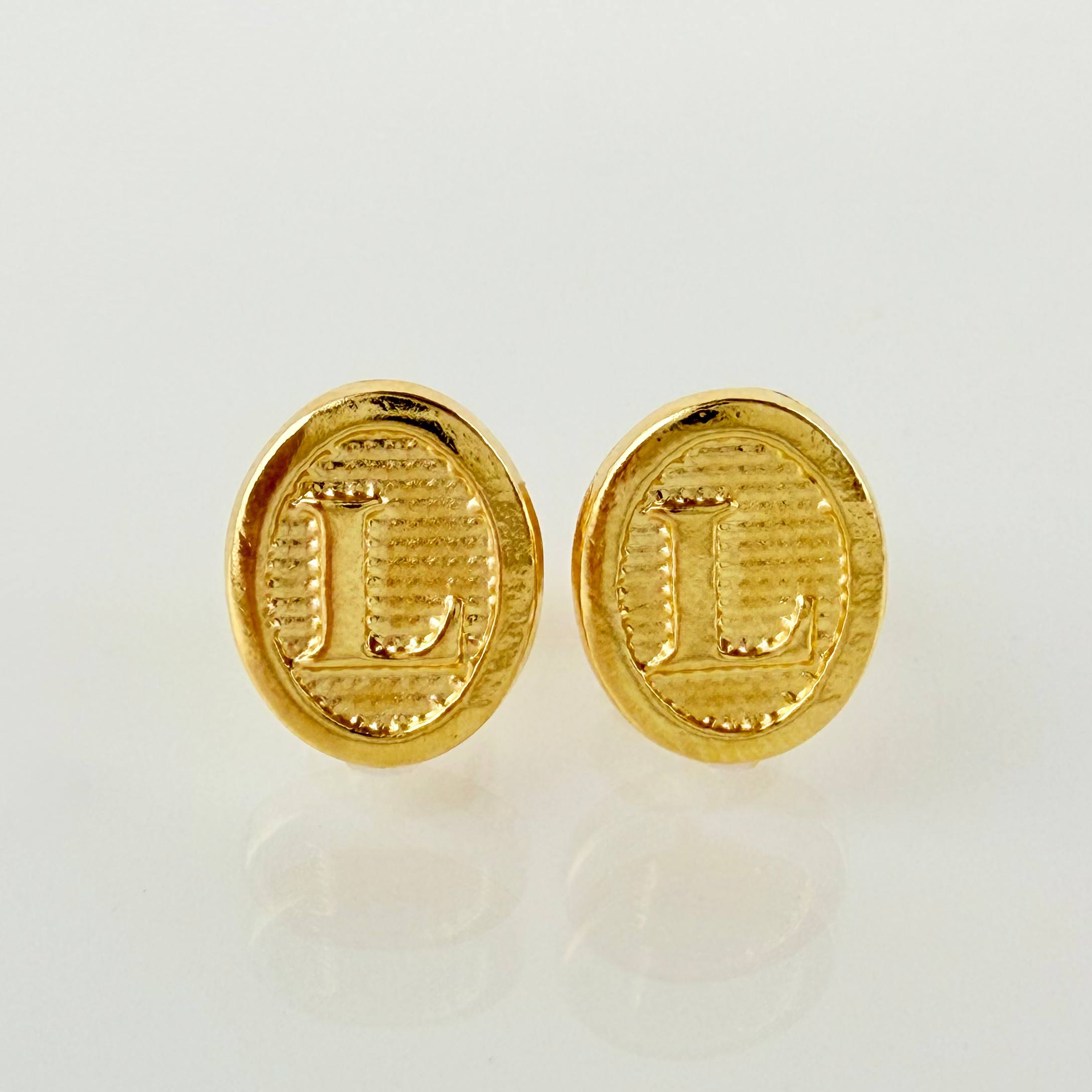 Topos Letra L 0.8gr / 9mm Oro Amarillo 18K ©