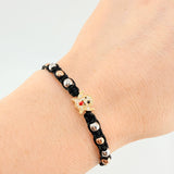 Pulsera Tejida Negra Herraje Fantasma / Bolas Lisas 8Und 4Mm- Bola Diamantada 6Und 3Mm Tres Oros 18K