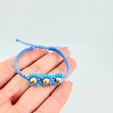 Pulsera Tejida Azul Trio Flores Oro Amarillo 18K