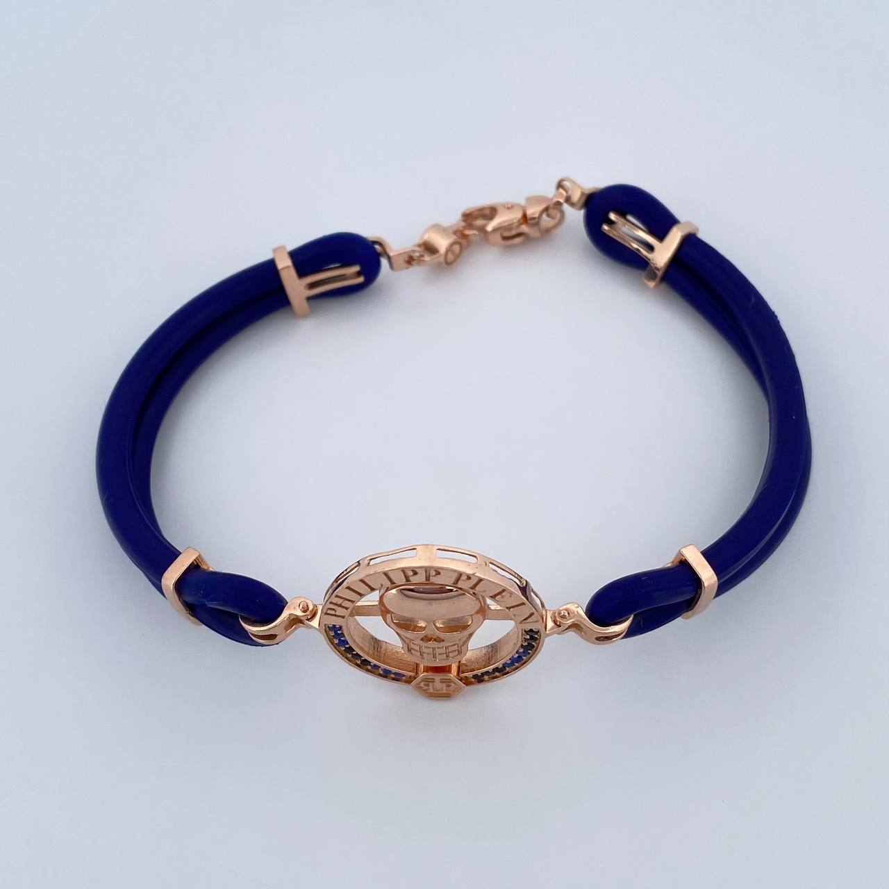 Pulso Calavera 12.9gr / 21.2cm / Cauchos Azules Circones Azules Negros Oro Rosa 18K &