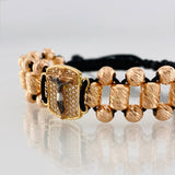 Black Woven Bracelet with Miraculous Christ of Buga Cross in Three 18K Golds