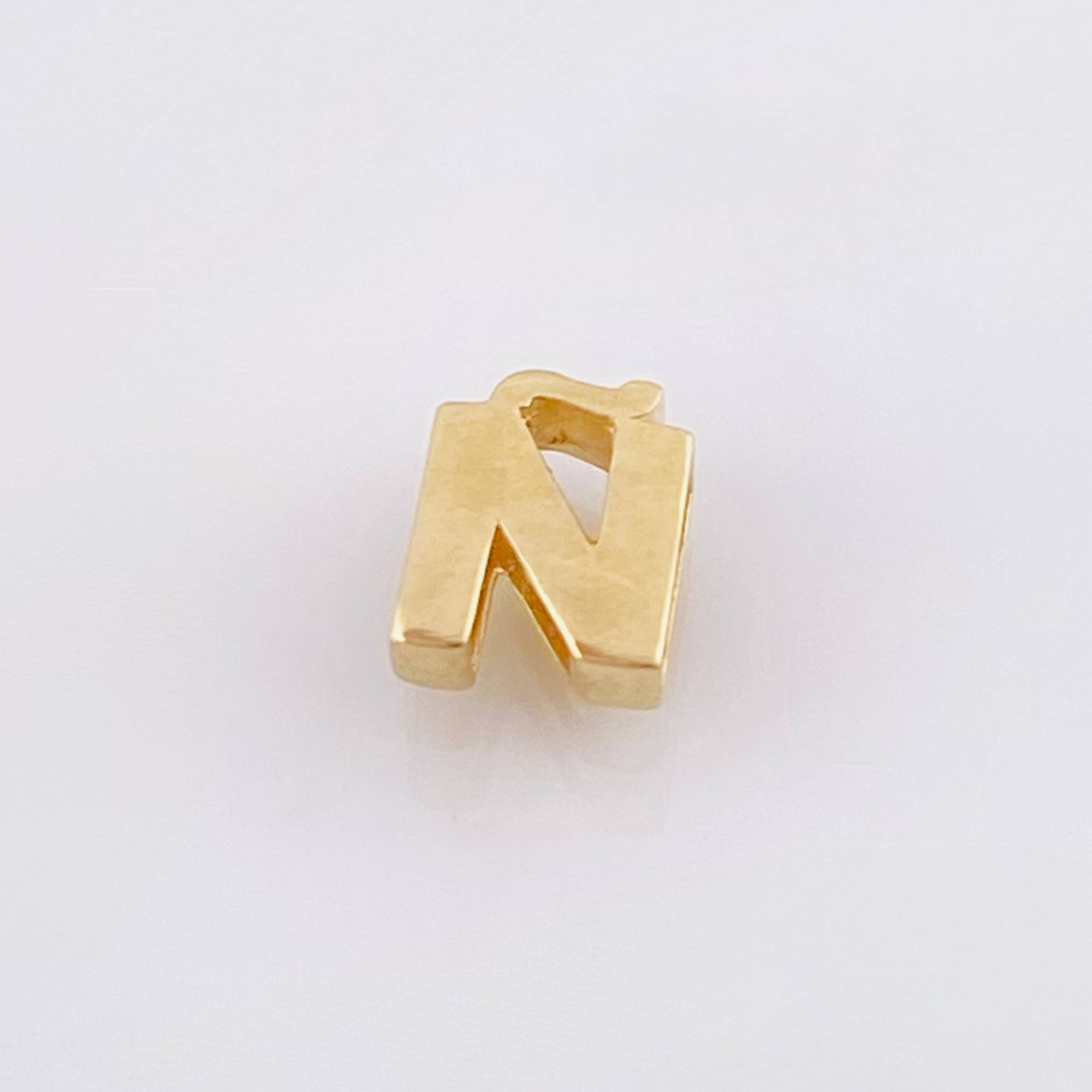 Herraje Tambor Letra Ñ 0.55gr / 7mm Oro Amarillo 18K