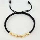 Pulsera Negra Cilindros Interceptos 7und / 4mm-5mm Oro Amarillo 18K  (A.C)