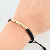 Pulsera Negra Cilindros Interceptos 7und / 4mm-5mm Oro Amarillo 18K  (A.C)