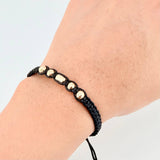 Pulsera Negra Cilindro Central 5und / 4mm-5mm Oro Amarillo 18K  (A.C)