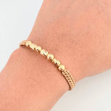 Pulsera Dorada Cilindros Interceptos 7und / 4mm-5mm Oro Amarillo 18K  (A.C)