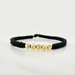 Pulsera Tejida Negra Bolas Diamantadas 4mm Oro Amarillo 18K