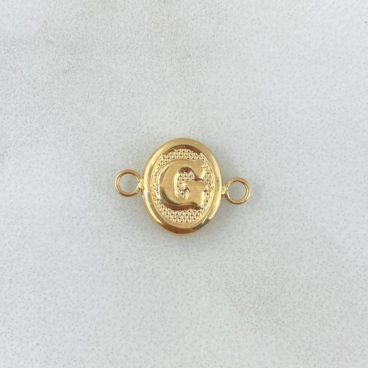 Herraje Letra G 0.4gr / 1.6cm / Ovalado Texturizado Oro Amarillo 18K