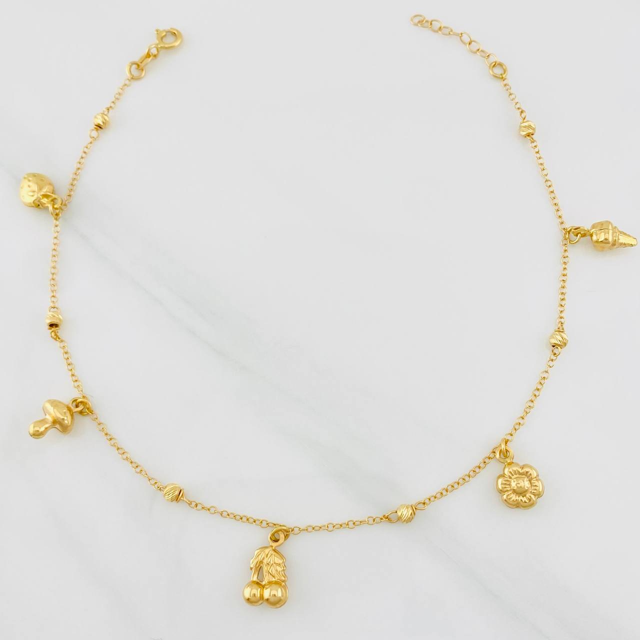 Tobillera Aro Seguido Figuras 3.55g / 9 3/4 in / 1.33mm Oro Amarillo 18K