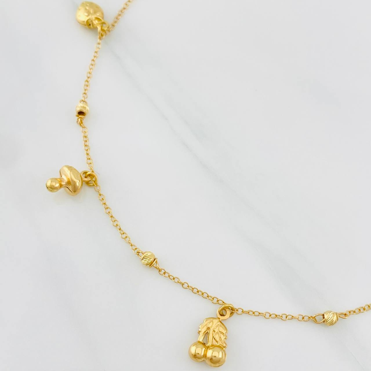 Tobillera Aro Seguido Figuras 3.55g / 9 3/4 in / 1.33mm Oro Amarillo 18K