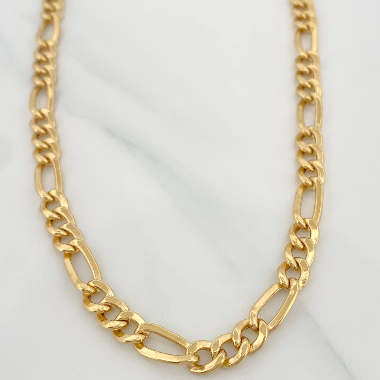 Cadena Figaro 19.45gr / 24 in / 5.04mm Oro Amarillo +1 18K $