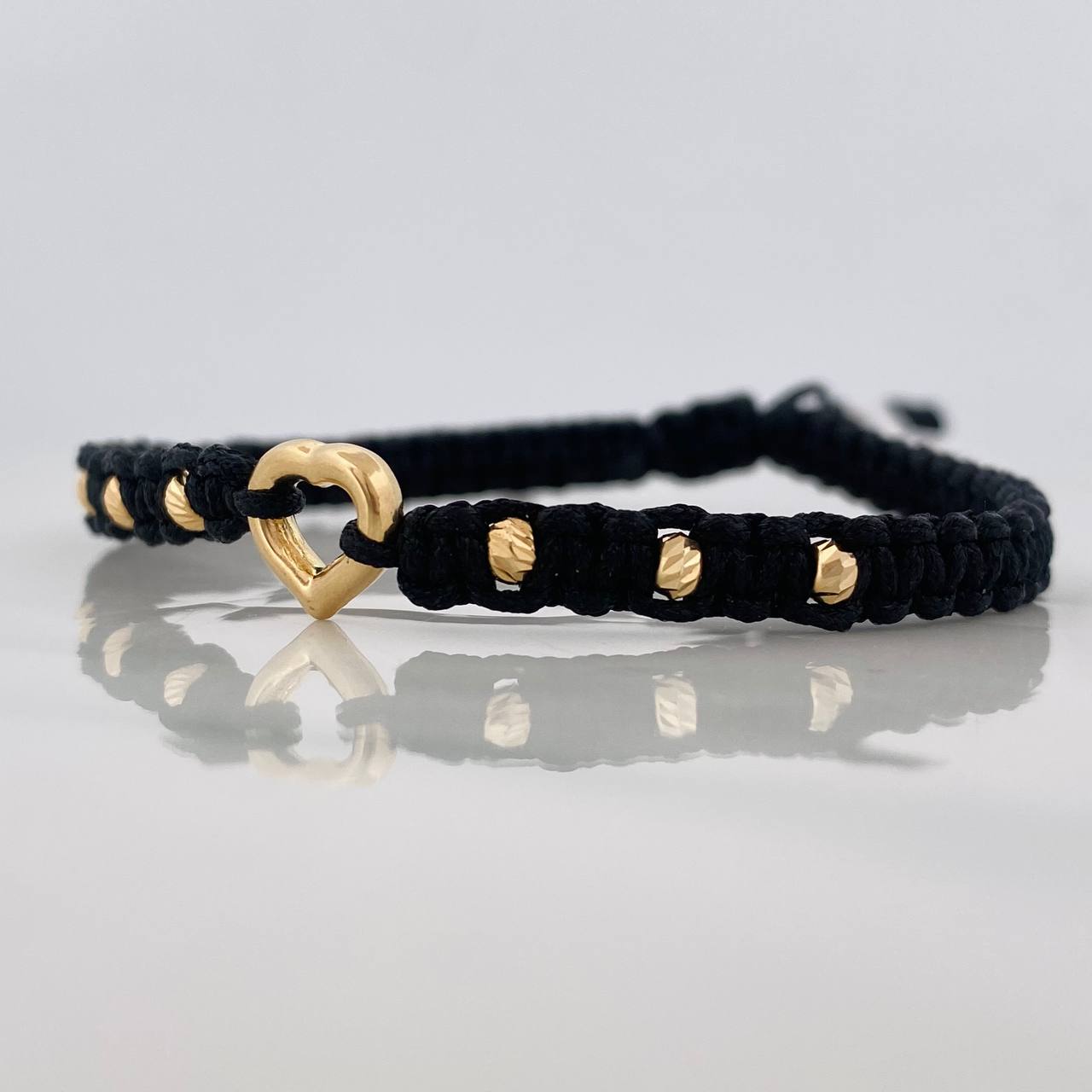 Pulsera Tejida Negra Corazón Bolas Diamantadas Oro Amarillo 18K