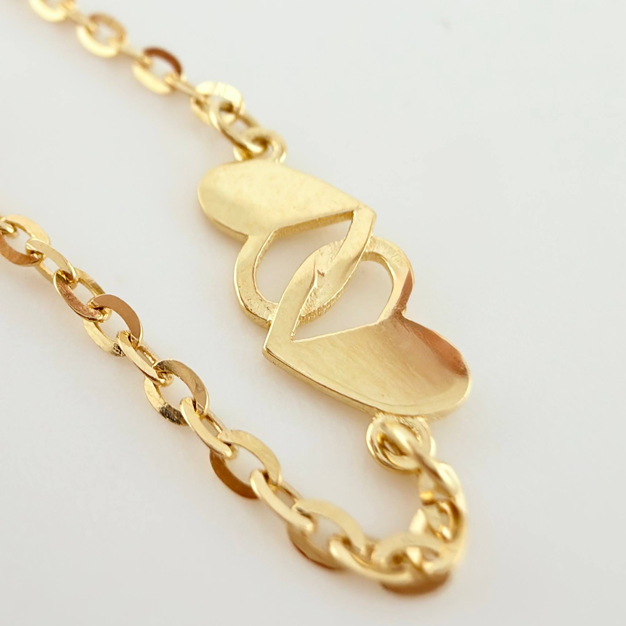 Pulso Aro Seguido Corazones Cruzados 1.95gr / 7 1/2 in / 1.2mm Oro Amarillo +4 18K ©