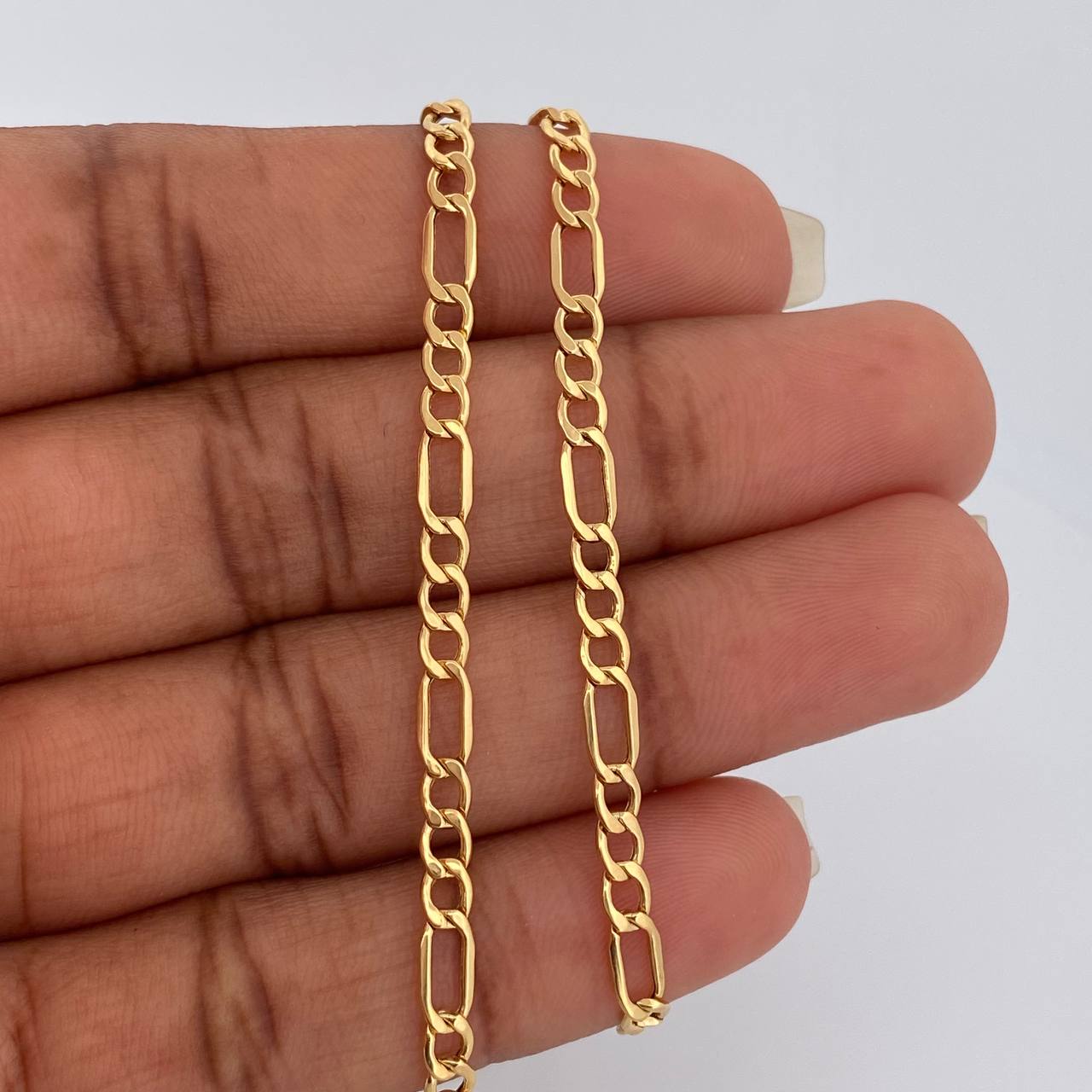 Cadena Figaro 5.5gr / 23 3/4 in / 3.38mm Oro Amarillo +1 18K &