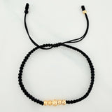 Pulsera Tejida Negra Bolas Diamantadas Oro Amarillo 18K