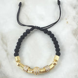 Pulsera Negra Herraje Rueda Abultada Circones Blancos  7.1gr / 6mm Bolas Diamantadas 2 und Cilindros 6und Oro Amarillo 18K ©