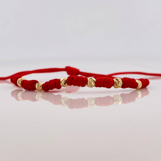 Pulsera Tejida Rojo Siete Nudos 6 Bolas Diamantadas Oro Amarillo 18K