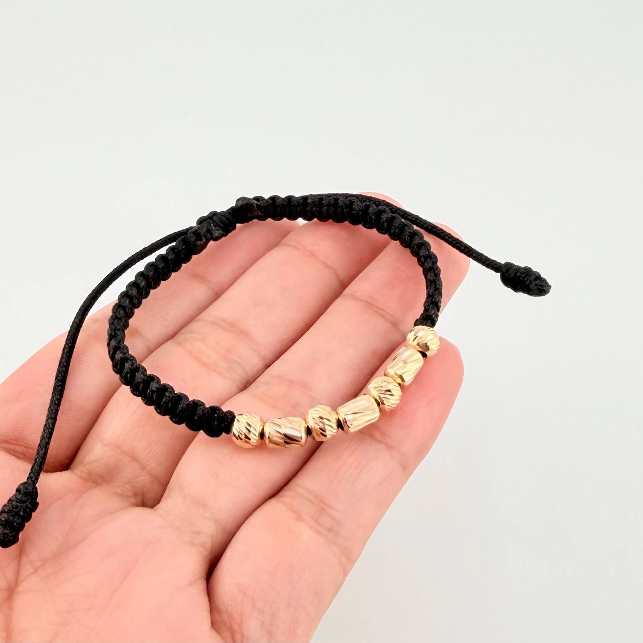 Black Woven Bracelet with Alternating Cylinders and Diamond Cut Beads in 18K Yellow Gold