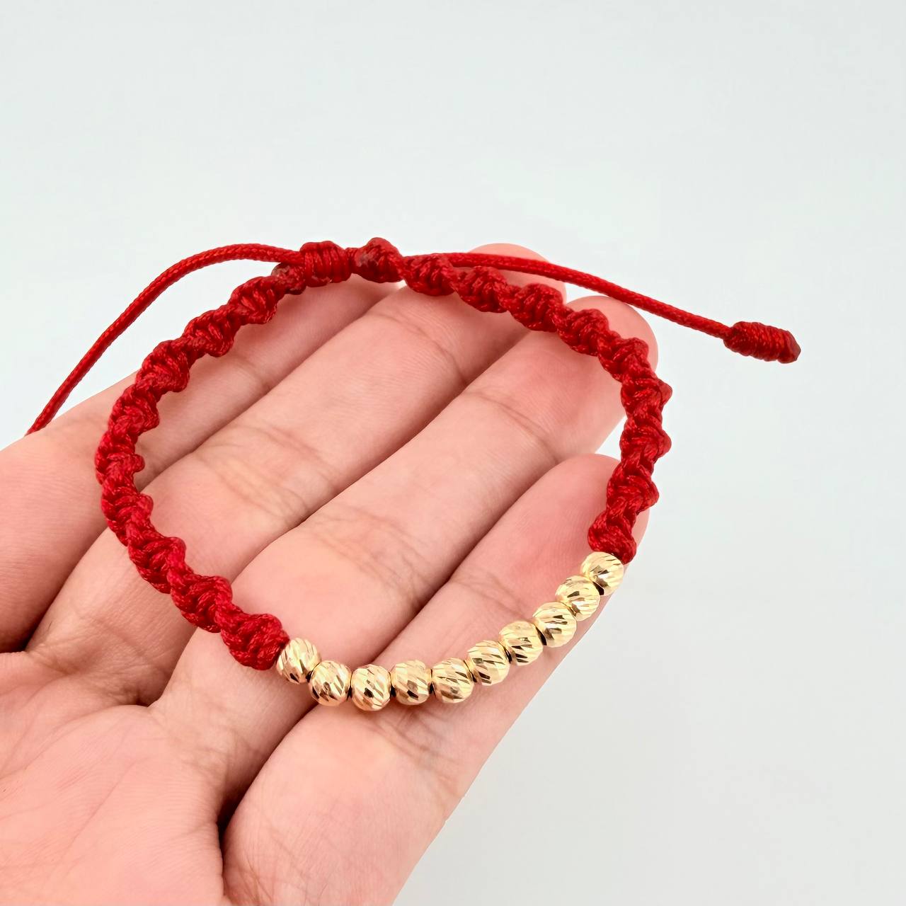 Red Woven Bracelet with Diamond Cut Beads in 18K Yellow Gold
