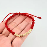 Red Woven Bracelet with Diamond Cut Beads in 18K Yellow Gold