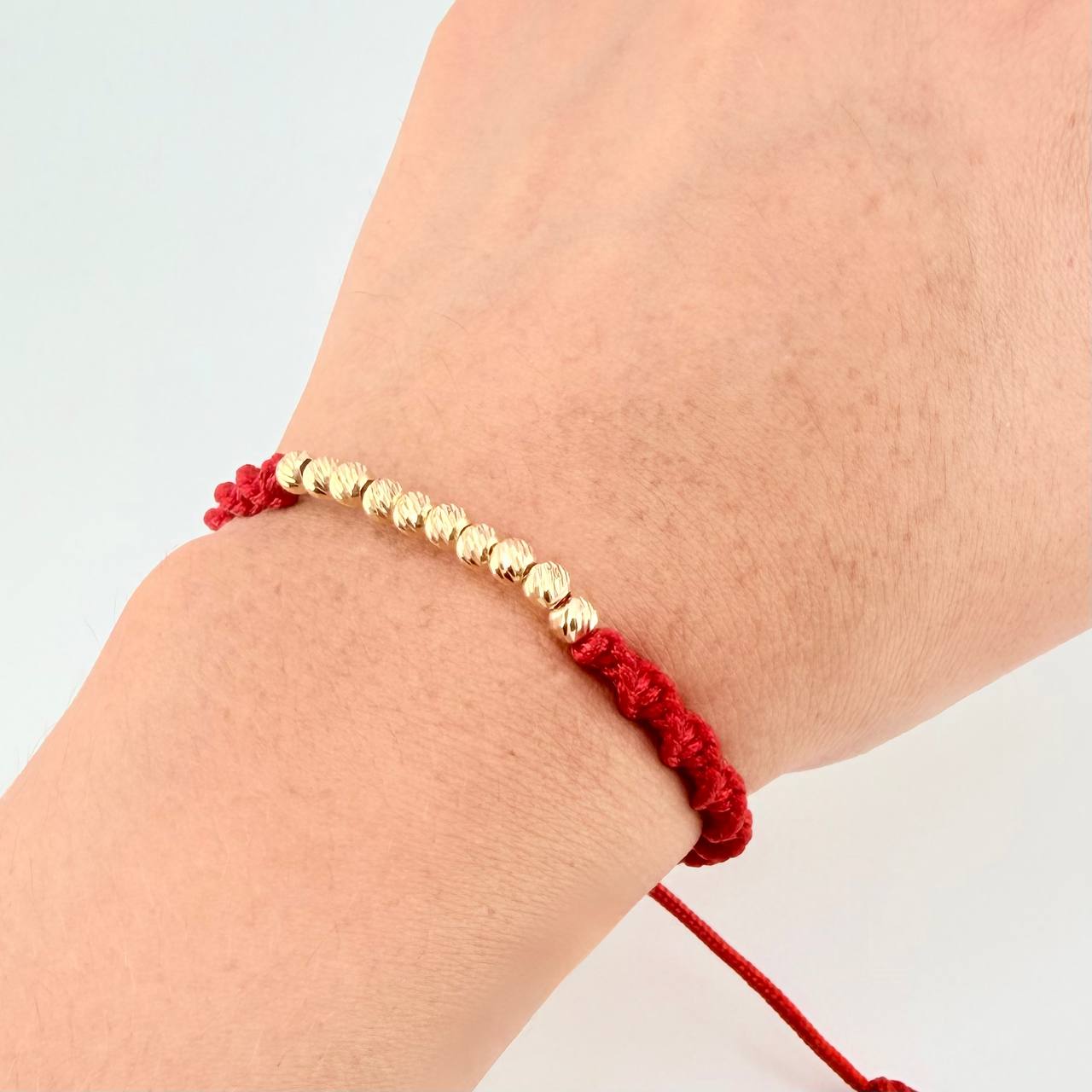 Red Woven Bracelet with Diamond Cut Beads in 18K Yellow Gold