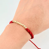Red Woven Bracelet with Diamond Cut Beads in 18K Yellow Gold