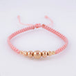 Pulsera Tejida Rosada Bolas Lisas/ Diamantadas Oro Amarillo 18K