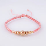 Pulsera Tejida Rosada Bolas Lisas/ Diamantadas Oro Amarillo 18K