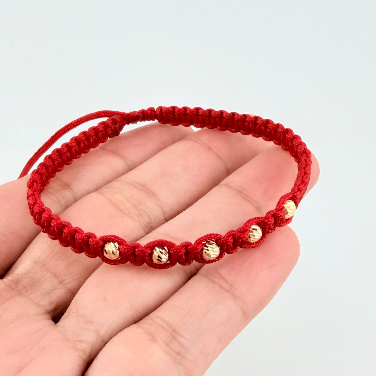 Red Woven Bracelet with Diamond Cut Beads in 18K Yellow Gold