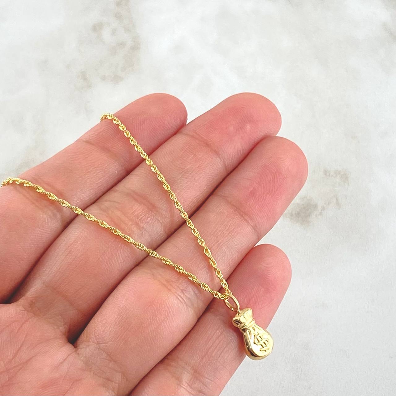Set Rope Chain 1.2gr / 23.6in / 1.2mm + Pendant Money Bag 0.5gr / 1.5cm (0.6in) / 1.7gr 18K Yellow Gold (Offer) ©